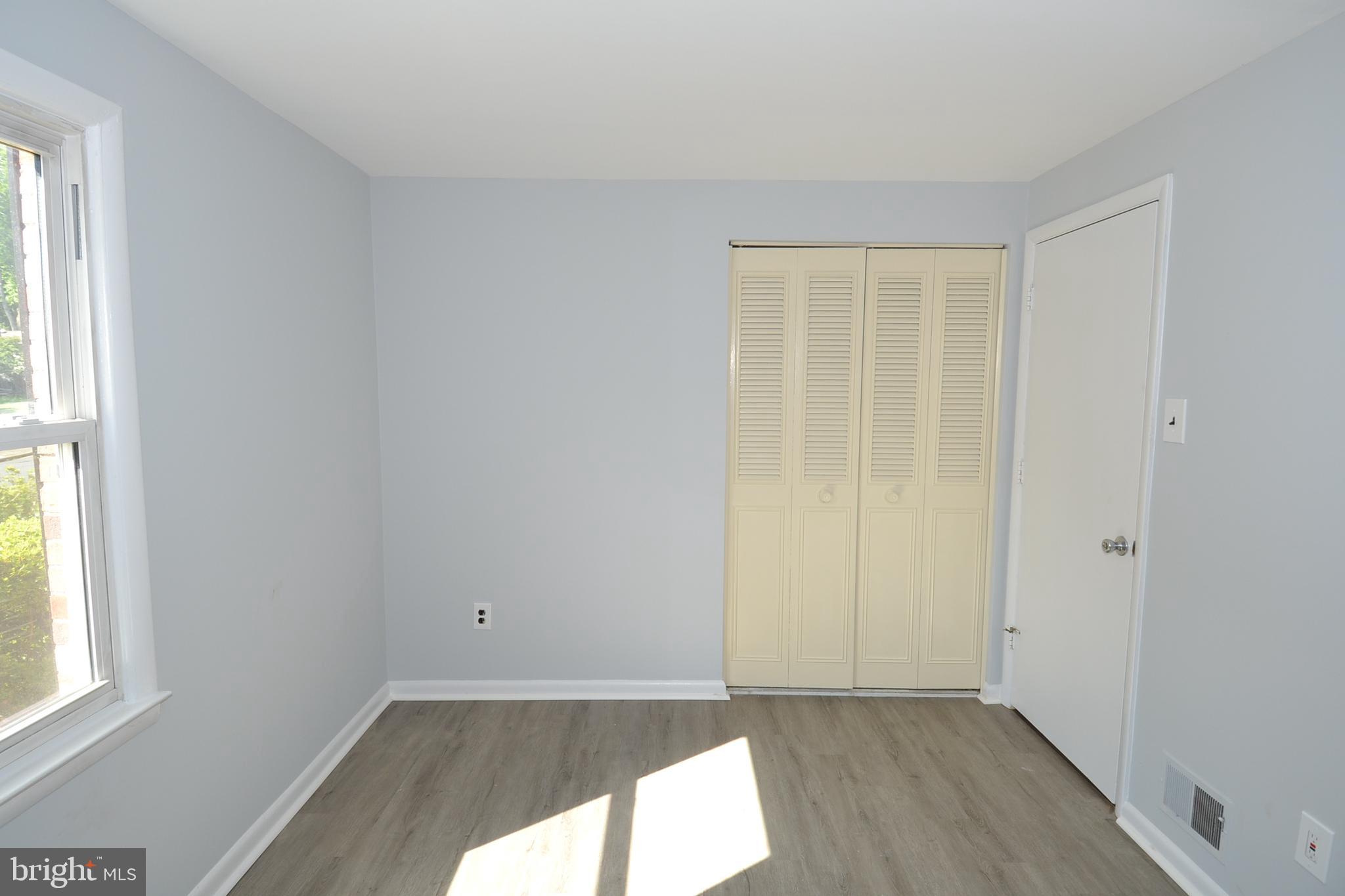 7103 Galgate Drive Springfield, VA 22152 - Photo 23 of 47 an empty room with wooden floor and windows