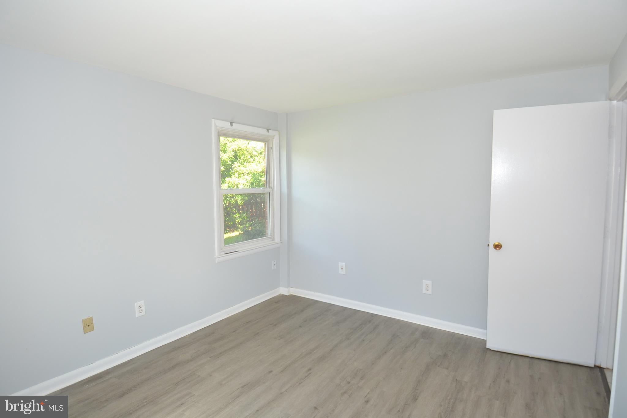 7103 Galgate Drive Springfield, VA 22152 - Photo 25 of 47 a view of an empty room with wooden floor and a window
