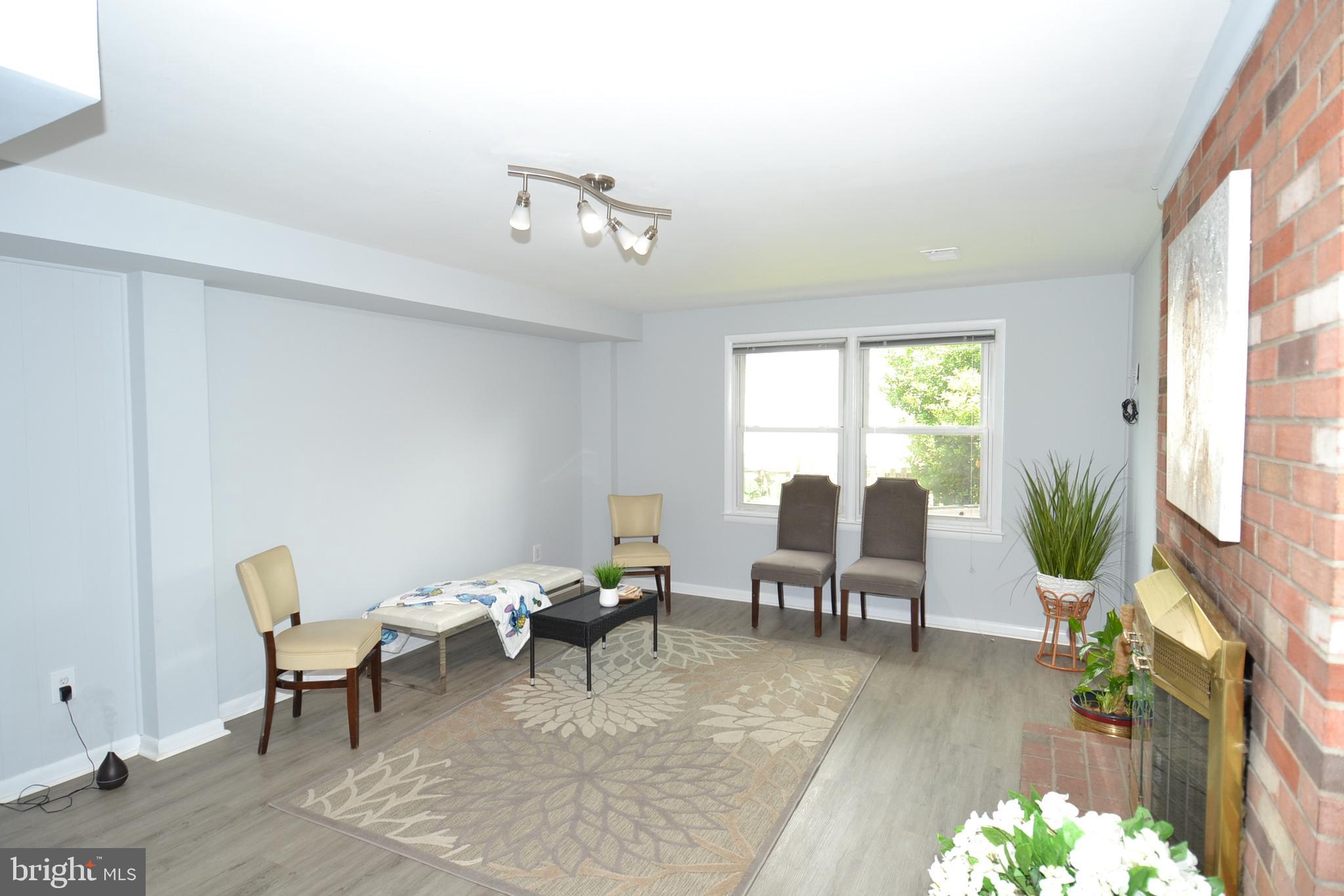 7103 Galgate Drive Springfield, VA 22152 - Photo 32 of 47 a living room with furniture and a large window