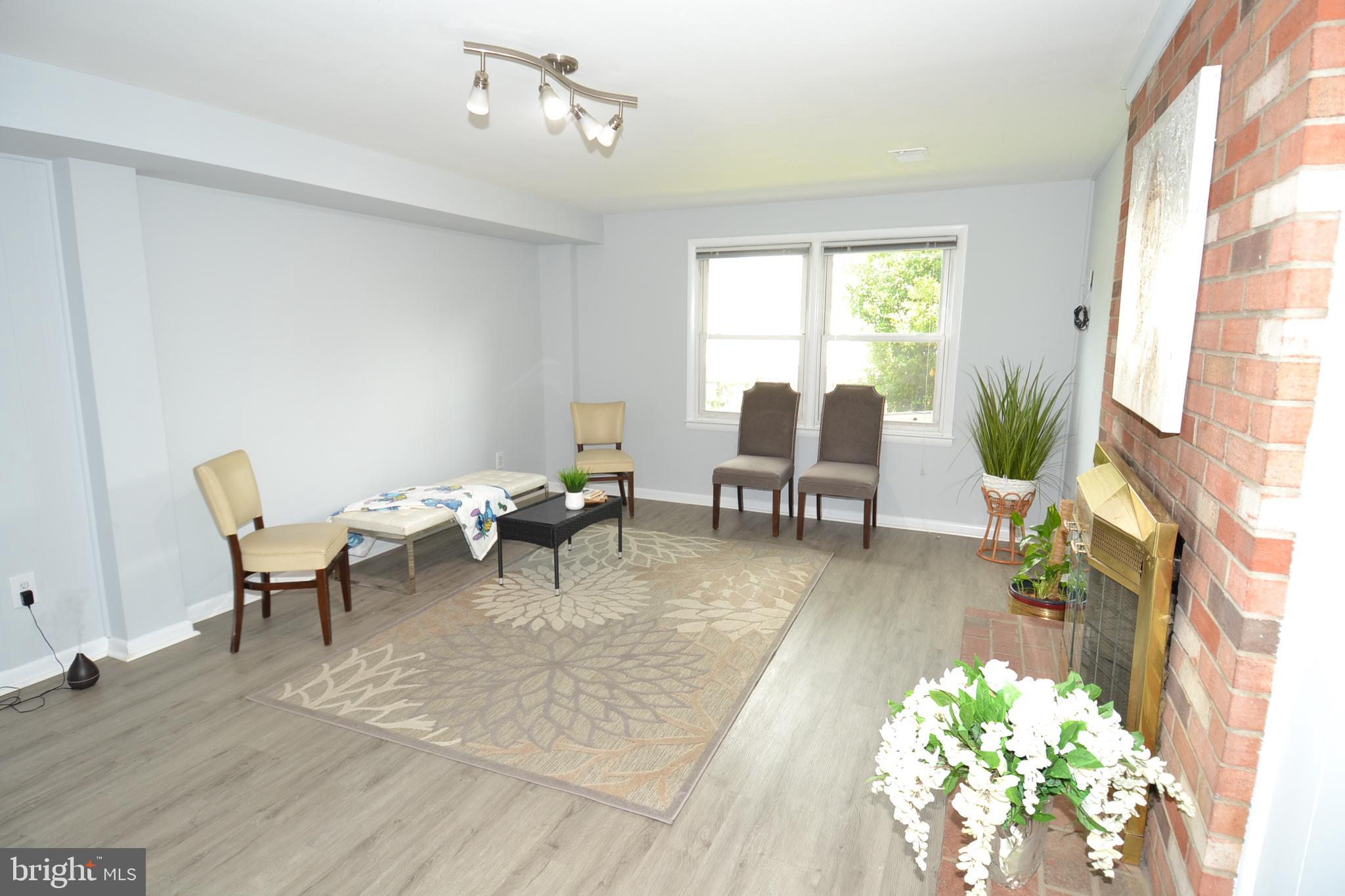 7103 Galgate Drive Springfield, VA 22152 - Photo 33 of 47 a living room with furniture dining table and a large window