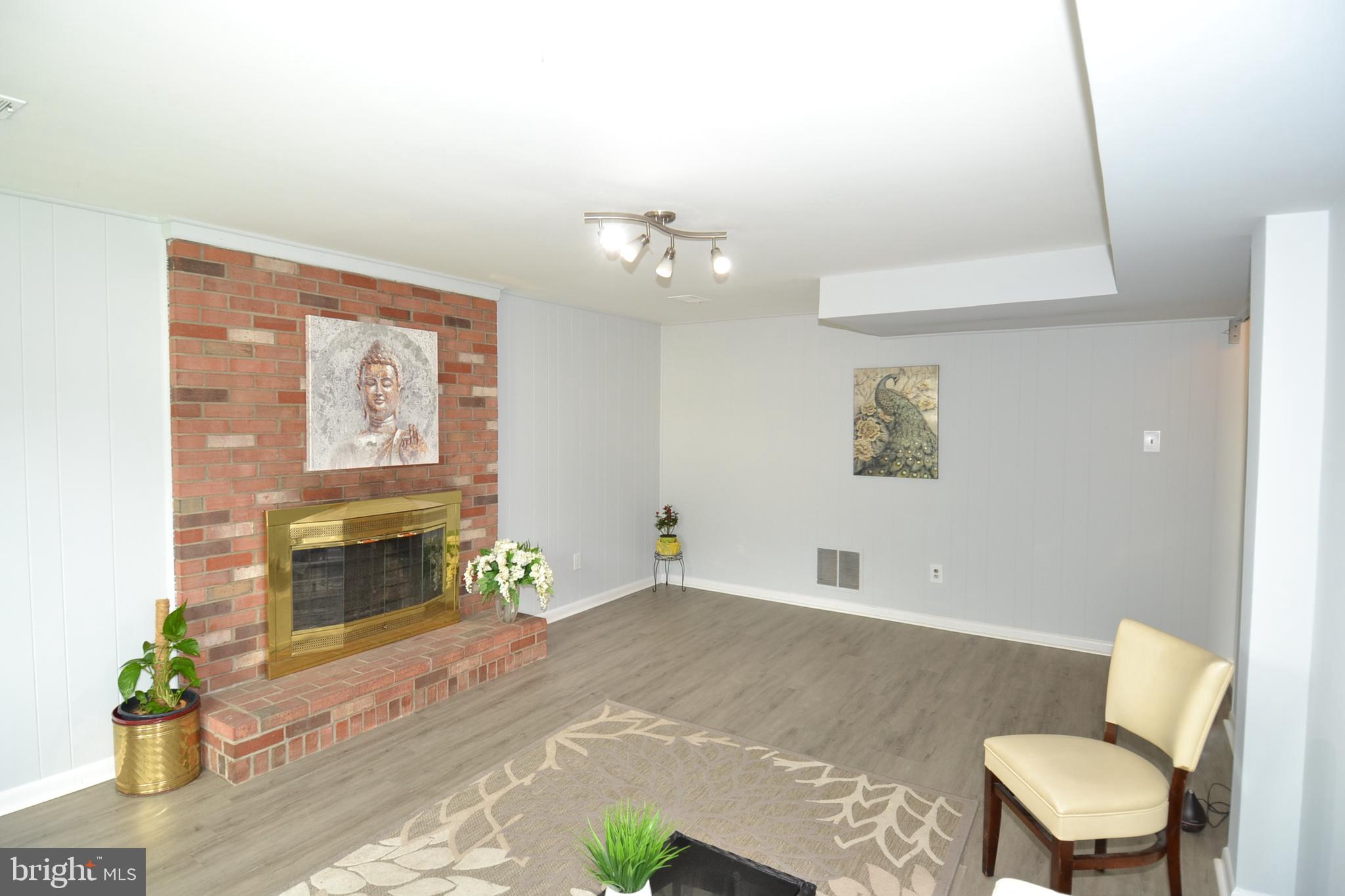 7103 Galgate Drive Springfield, VA 22152 - Photo 37 of 47 a living room with furniture and a fireplace