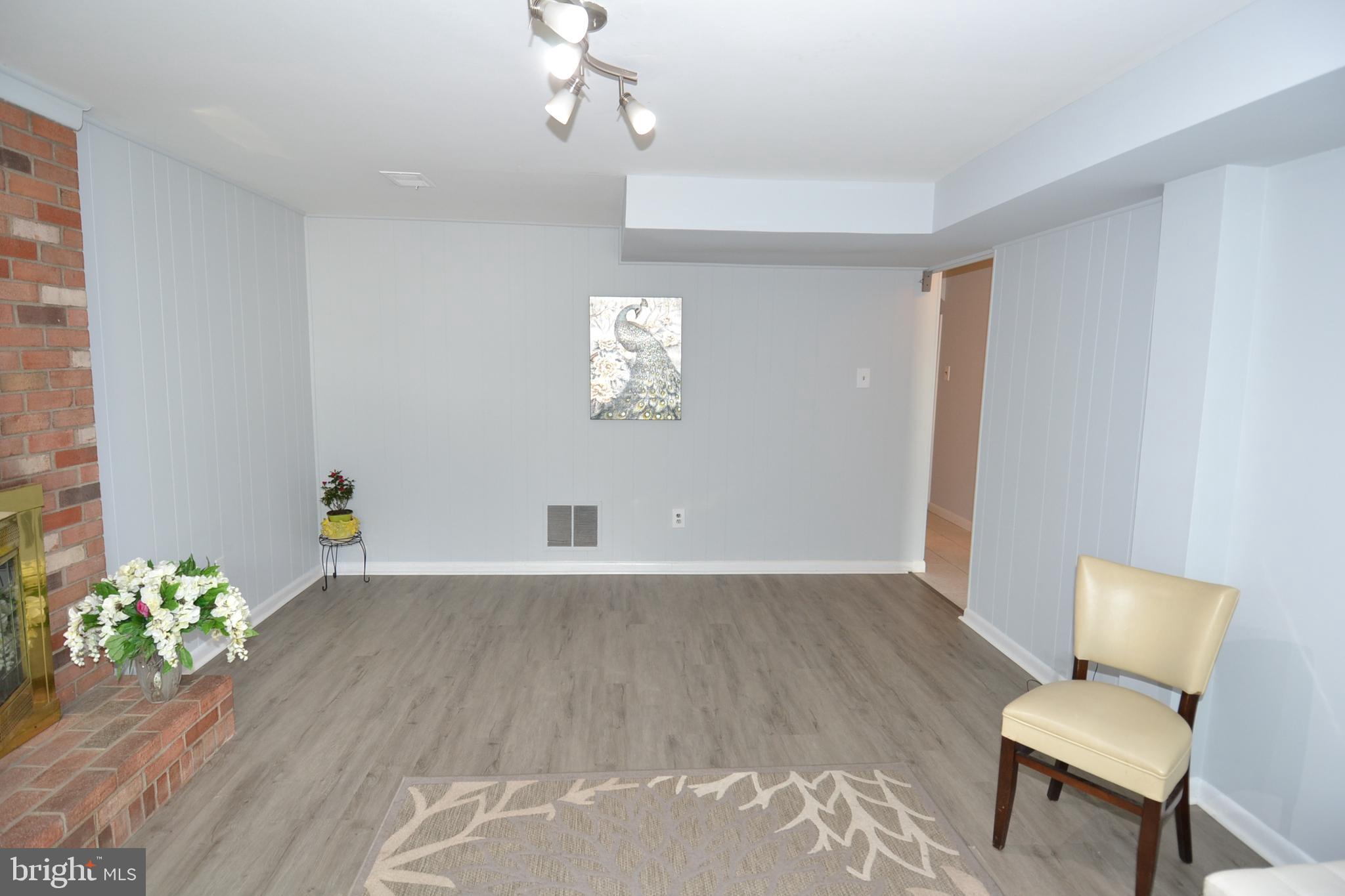 7103 Galgate Drive Springfield, VA 22152 - Photo 38 of 47 a view of an empty room with wooden floor and a window