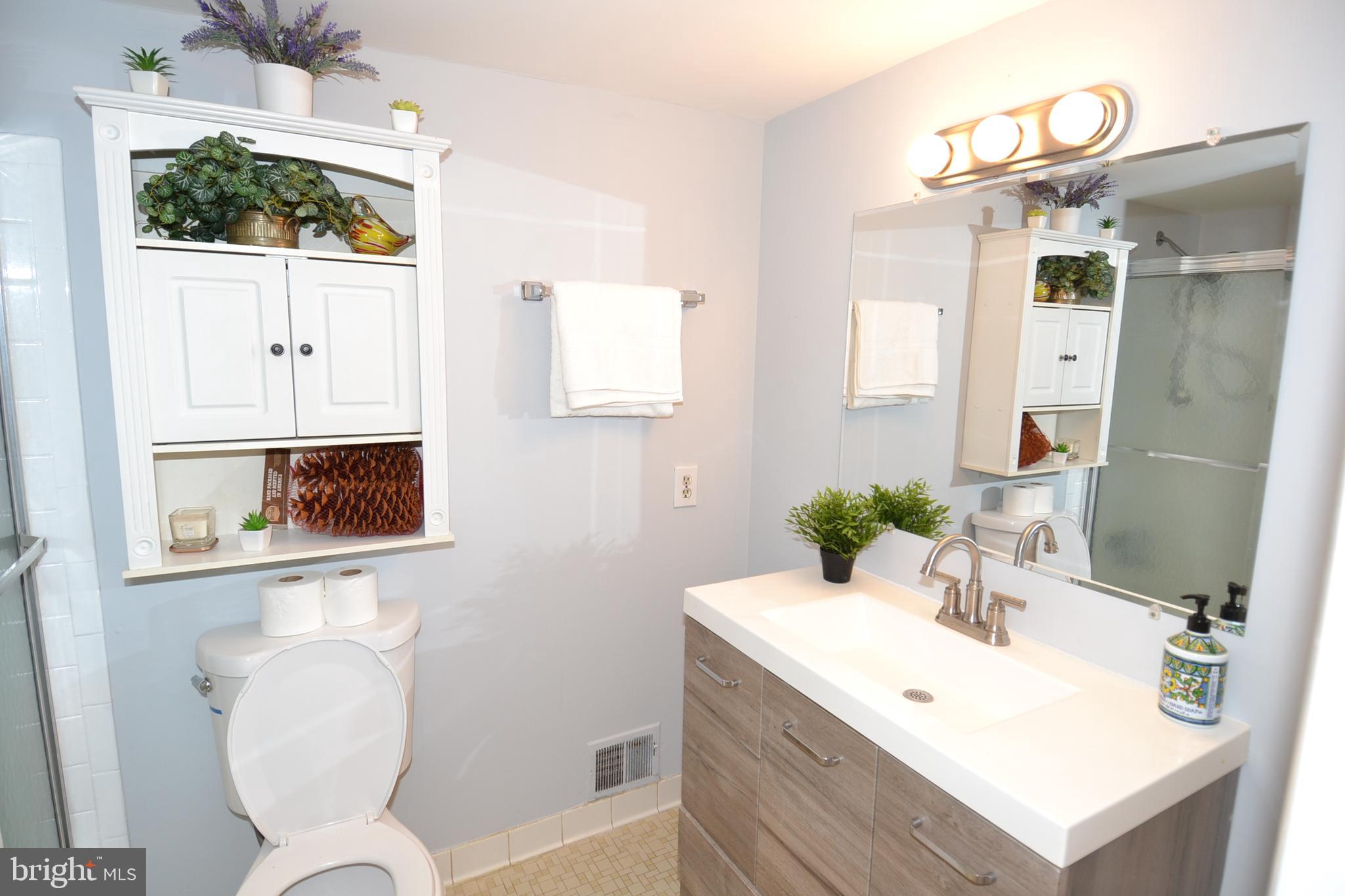 7103 Galgate Drive Springfield, VA 22152 - Photo 41 of 47 a bathroom with a sink mirror and vanity