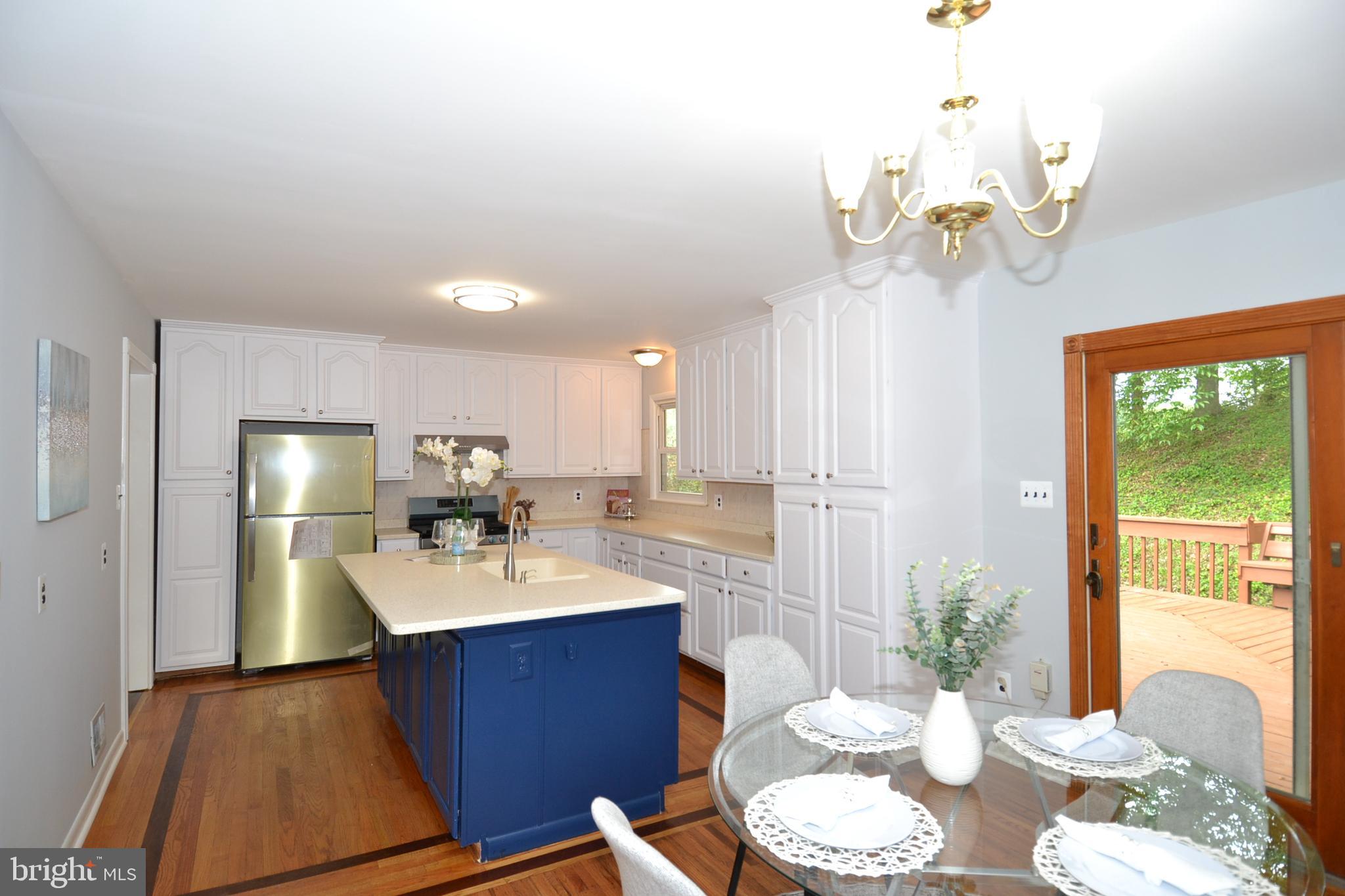 7103 Galgate Drive Springfield, VA 22152 - Photo 6 of 47 a kitchen with a sink chandelier and living room view