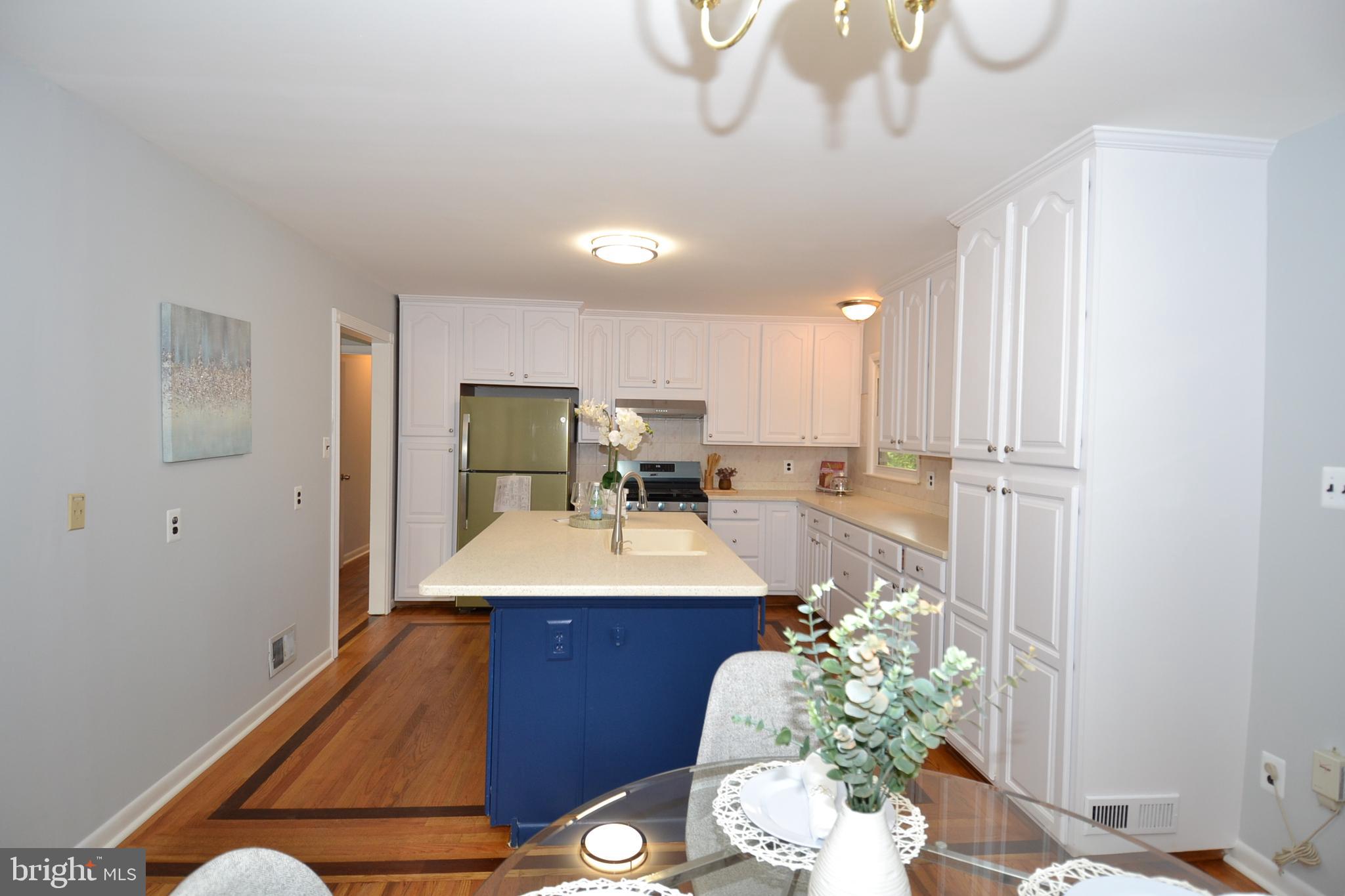 7103 Galgate Drive Springfield, VA 22152 - Photo 7 of 47 a room with stainless steel appliances furniture a chandelier and a view of kitchen