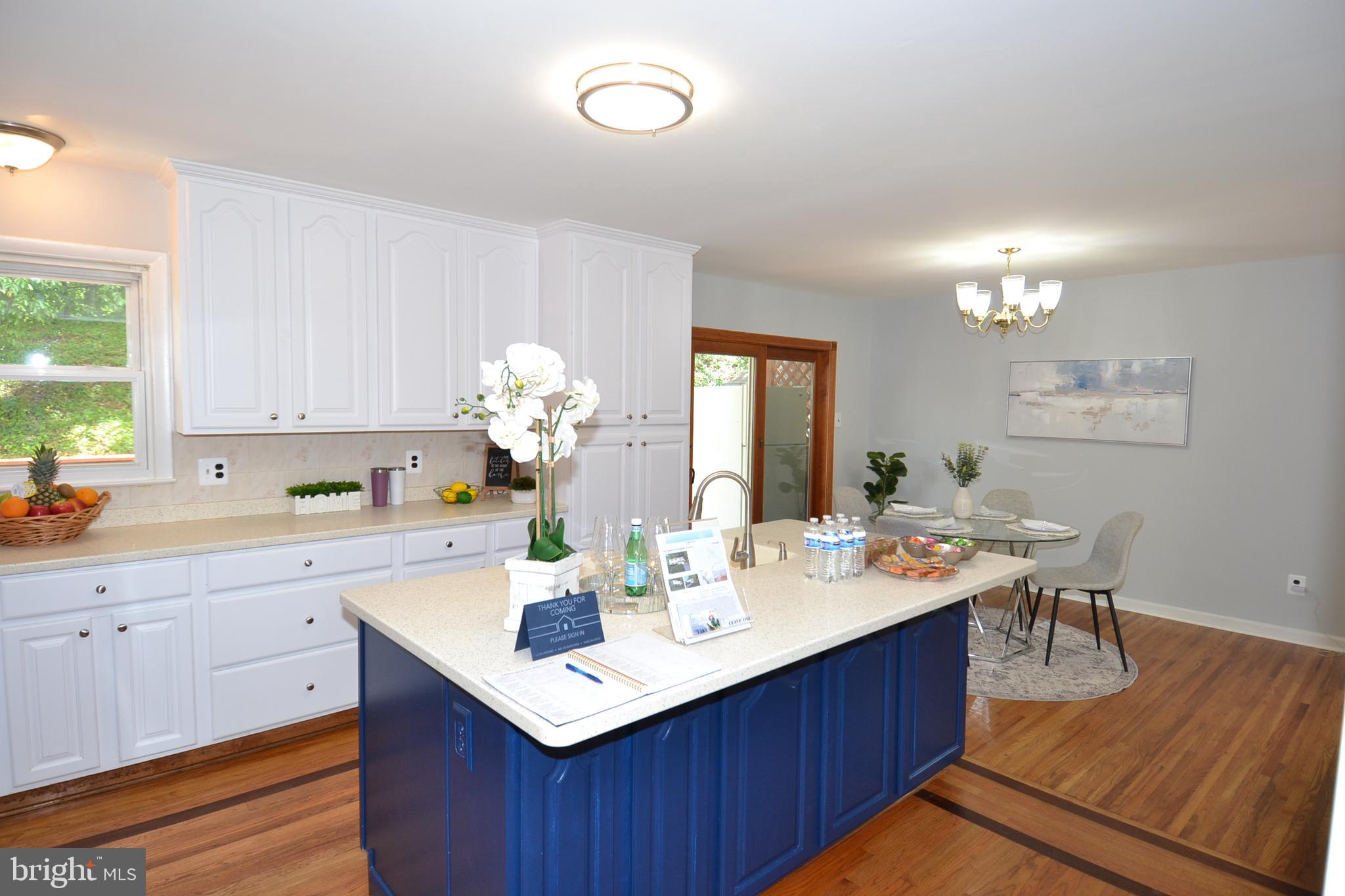 7103 Galgate Drive Springfield, VA 22152 - Photo 8 of 47 a kitchen with a sink cabinets and wooden floor