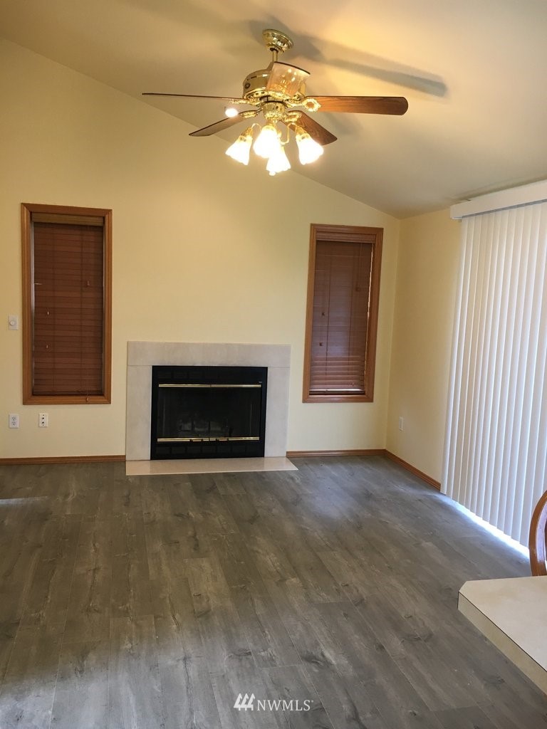 896 King Road Winlock, WA 98596 - Photo 3 of 39 a view of an empty room with a fireplace and a window