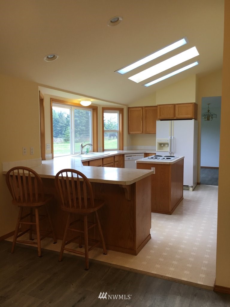 896 King Road Winlock, WA 98596 - Photo 6 of 39 a kitchen with a table chairs and a refrigerator