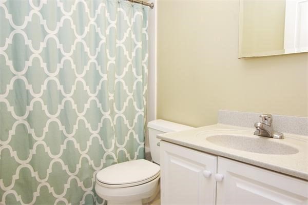 4 Charlesgate East, Unit 602 Boston, MA 02215 - Photo 12 of 24 a bathroom with a sink a toilet and a mirror