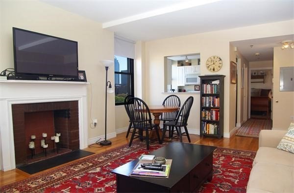 4 Charlesgate East, Unit 602 Boston, MA 02215 - Photo 2 of 24 a living room with furniture a flat screen tv and a fireplace
