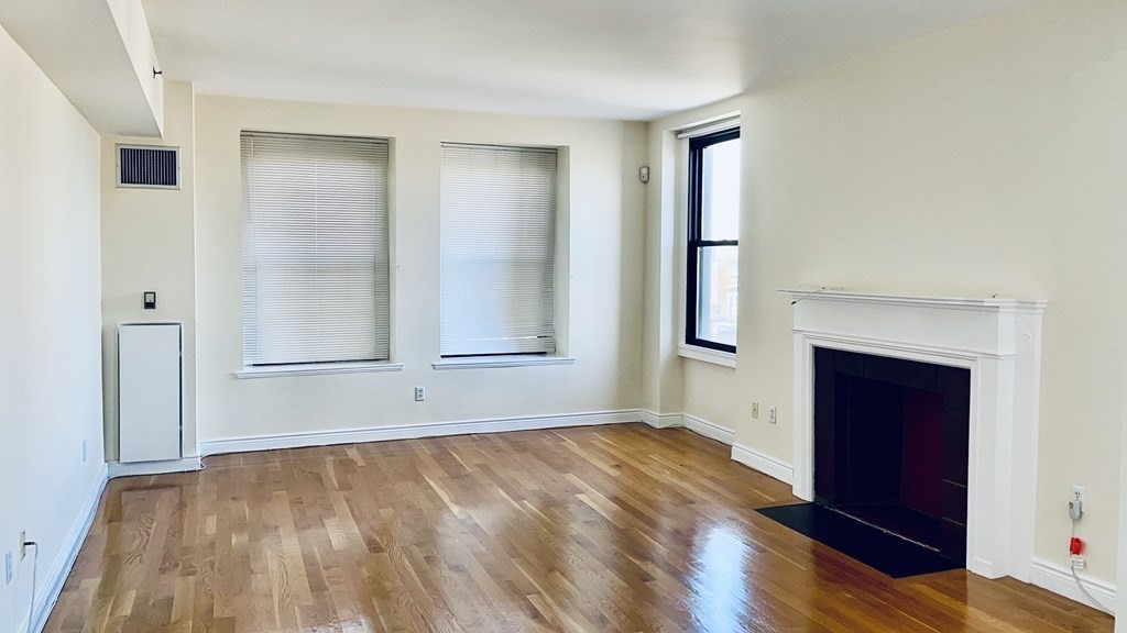 4 Charlesgate East, Unit 602 Boston, MA 02215 - Photo 4 of 24 an empty room with wooden floor and windows