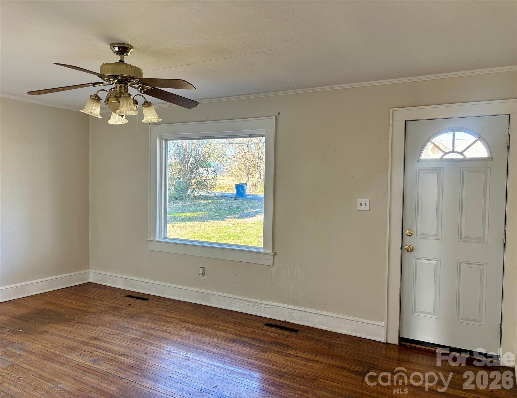 2145 14th Avenue Southwest Hickory, NC 28602 - Photo 4 of 17 a view of an empty room with window and wooden floor