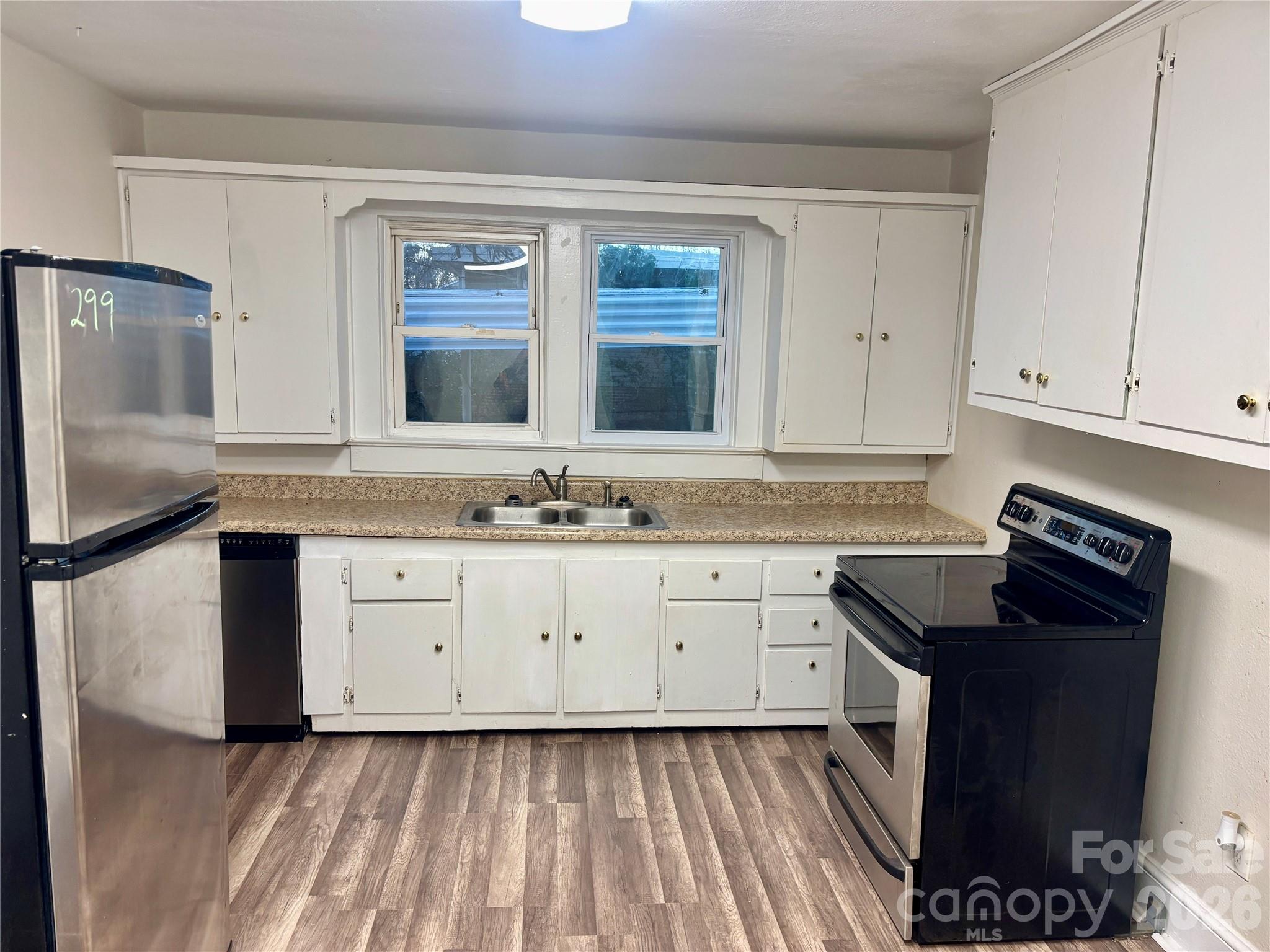 2145 14th Avenue Southwest Hickory, NC 28602 - Photo 6 of 17 a kitchen with granite countertop a sink stove and cabinets