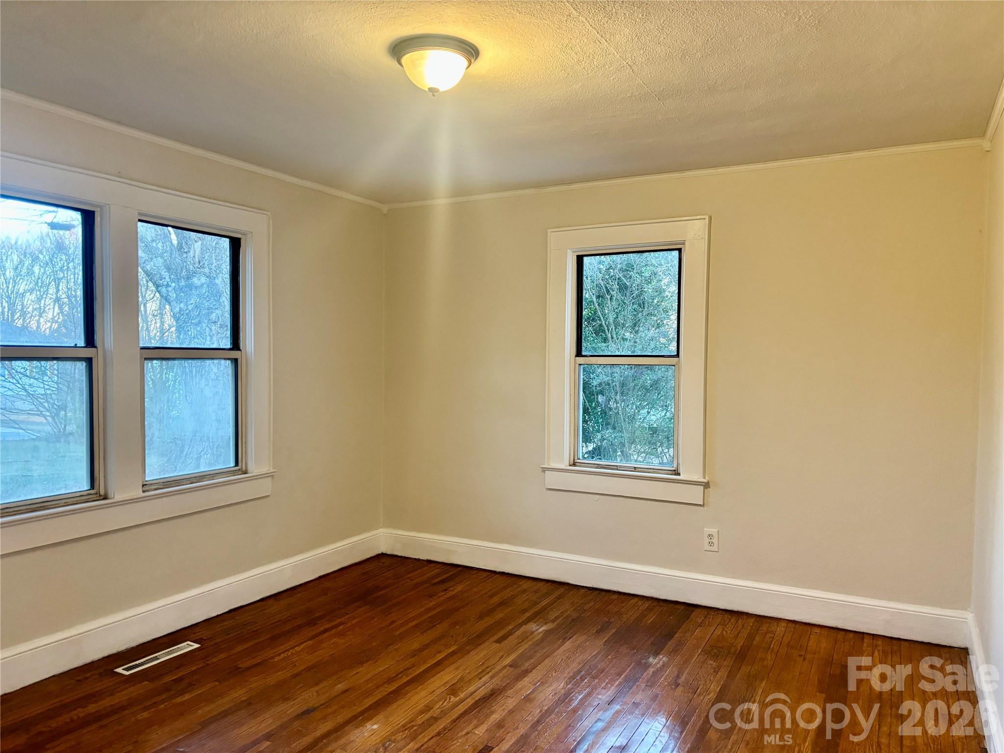 2145 14th Avenue Southwest Hickory, NC 28602 - Photo 8 of 17 an empty room with wooden floor and windows