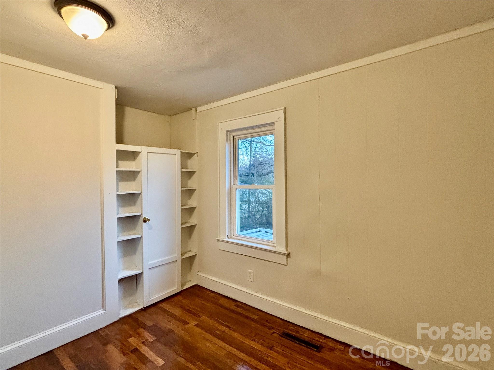2145 14th Avenue Southwest Hickory, NC 28602 - Photo 10 of 17 a view of an empty room with a window and wooden floor