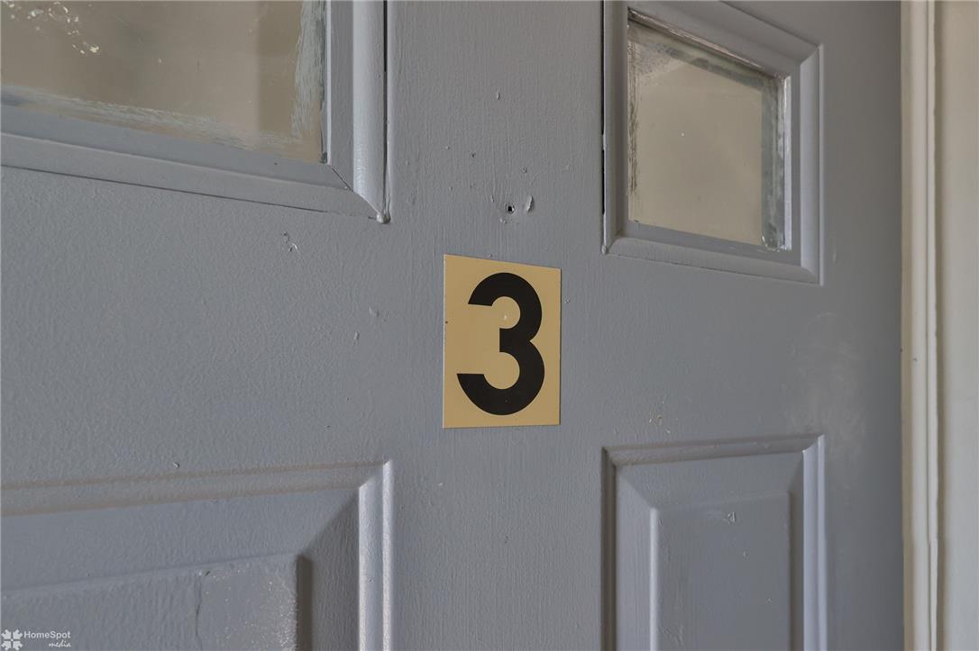 115 East Ruddle Street Coaldale, PA 18218 - Photo 38 of 57 A paneled wooden door features integrated glass panes, marking a distinct residential entrance.