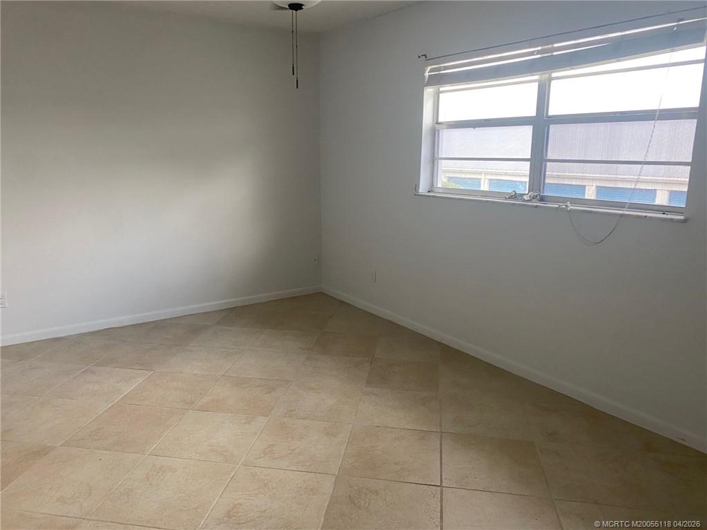 2118 Southeast Edler Drive, Unit B Stuart, FL 34994 - Photo 6 of 6 an empty room with a window