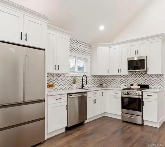 a kitchen with a sink stove and refrigerator