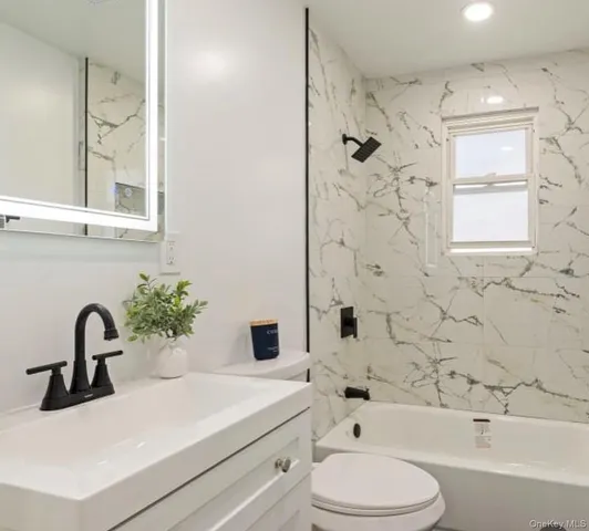 a bathroom with a sink a toilet and a bathtub