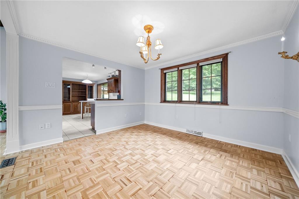 94 Ohare Road Canonsburg, PA 15317 - Photo 10 of 50 Dining room flows seamlessly into the kitchen, with warm parquet flooring, abundant natural light and plenty of space for everyday meals or larger gatherings.