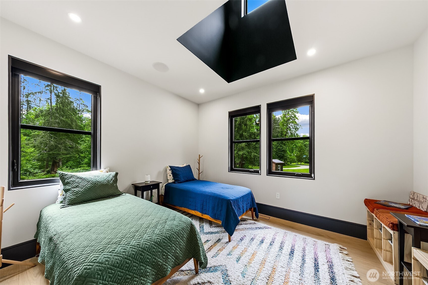 7538 Moon Valley Road Southeast North Bend, WA 98045 - Photo 22 of 40 a bedroom with two beds and a large window