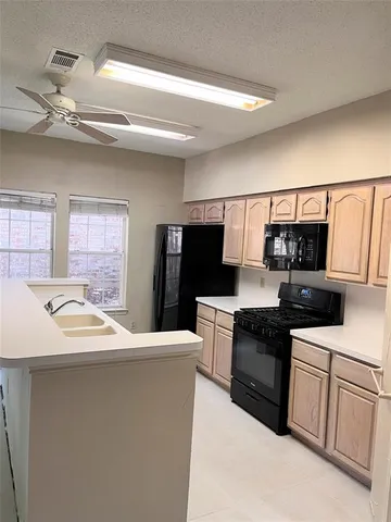 a kitchen with stainless steel appliances a sink dishwasher stove refrigerator and microwave