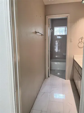a bathroom with a vanity and a tub