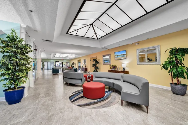 a living room with furniture a potted plant and a potted plant