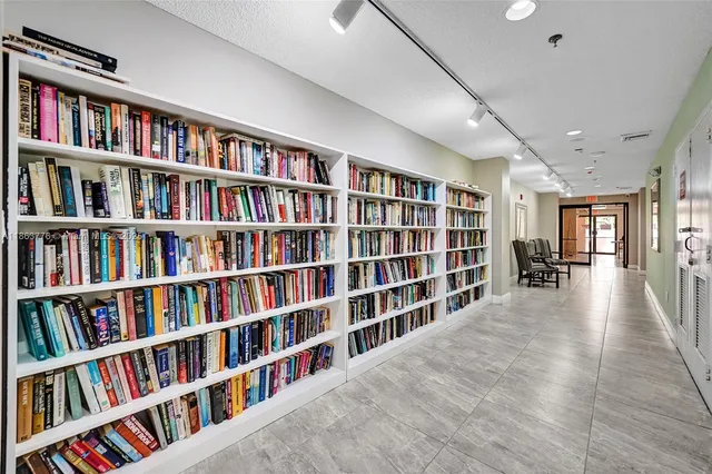 a hallway with a book shelf and a book shelf