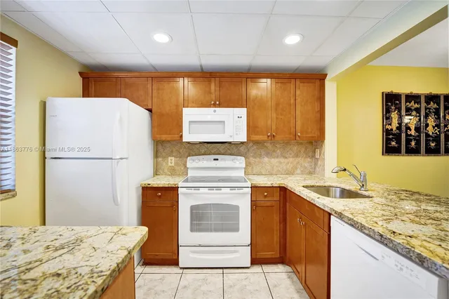 a kitchen with a stove a sink and a refrigerator