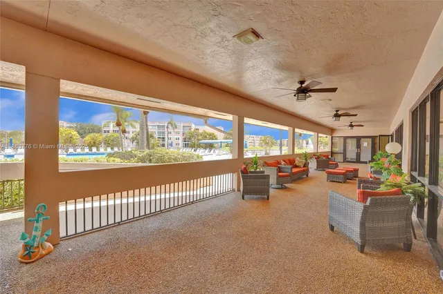a view of a livingroom with furniture and floor to ceiling window