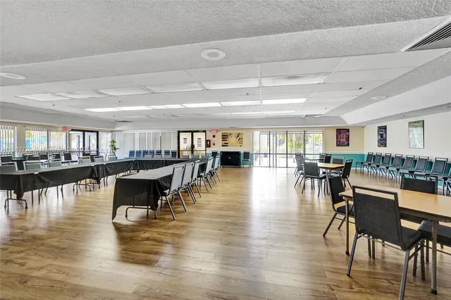 a dining room with wooden floor and pool table