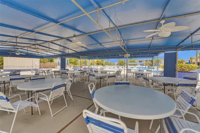a dining room with furniture and a floor to ceiling window