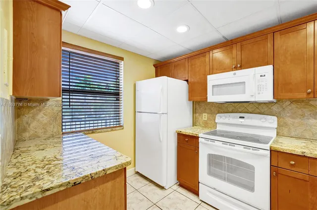 a view of a kitchen with a stove top oven