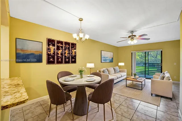 a view of a dining room with furniture and a chandelier