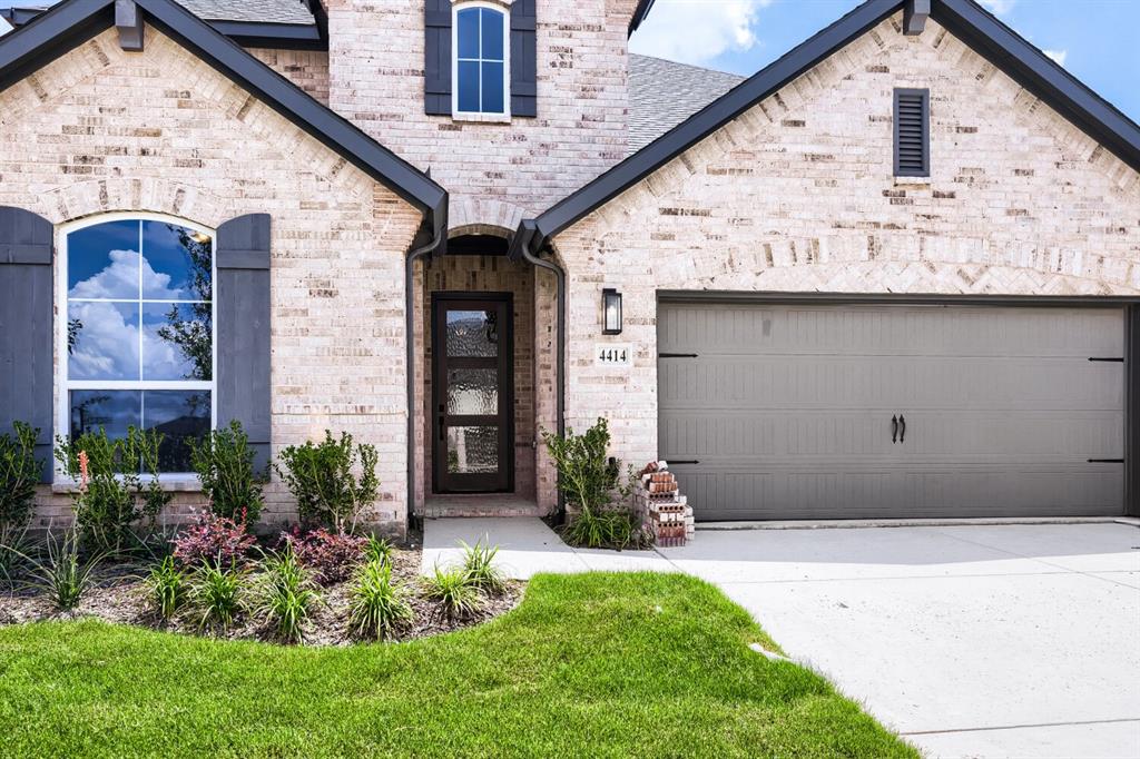 4414 Windy Point Road Oak Point, TX 75068 - Photo 2 of 27 a front view of a house with garden