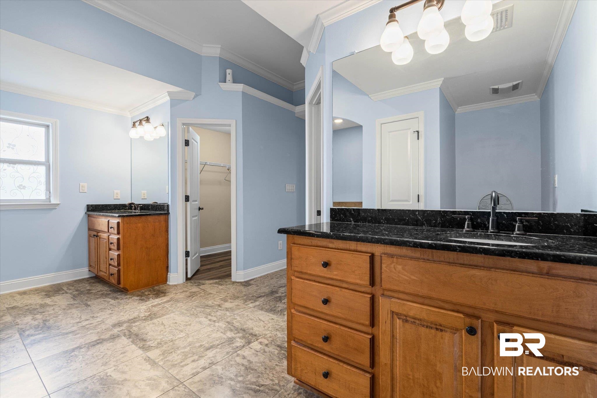 704 Edinburgh Avenue Foley, AL 36535 - Photo 20 of 32 Bathroom featuring two vanities, a spacious closet, and crown molding