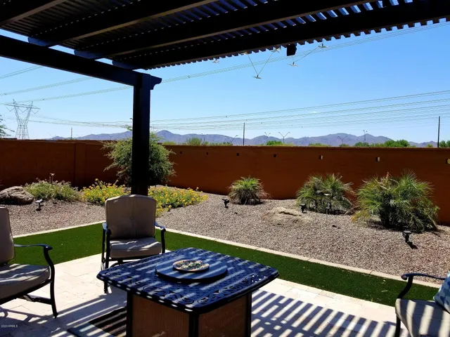 a view of a patio with table and chairs and potted plants