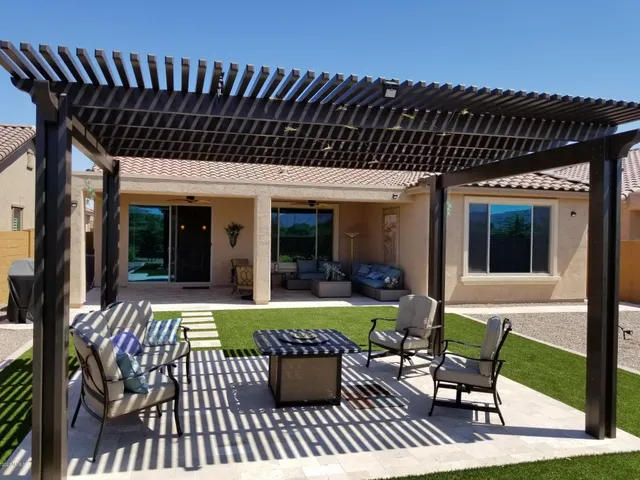 a view of a house with backyard porch and sitting area