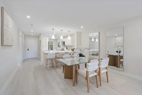 a living room with dining table a table and chairs