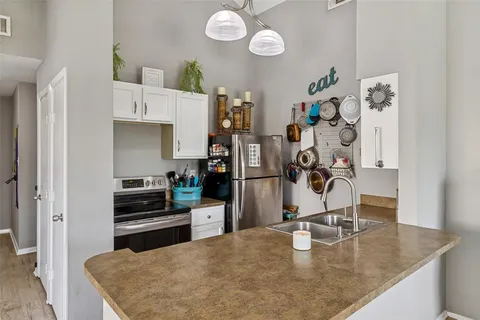a kitchen with stainless steel appliances granite countertop a sink a stove and refrigerator