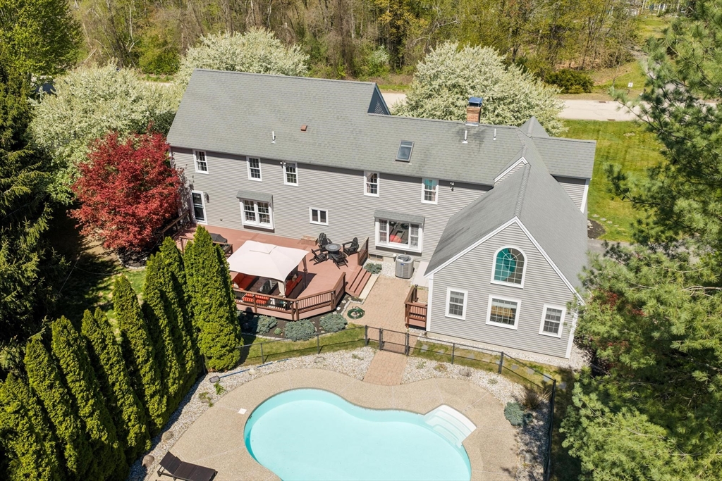 4 Ridge Road Pepperell, MA 01463 - Photo 42 of 42 an aerial view of a house with swimming pool and large trees
