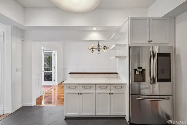 a kitchen with stainless steel appliances granite countertop a refrigerator and a stove