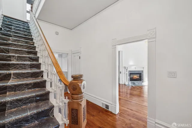a view of entryway with wooden floor and stairs