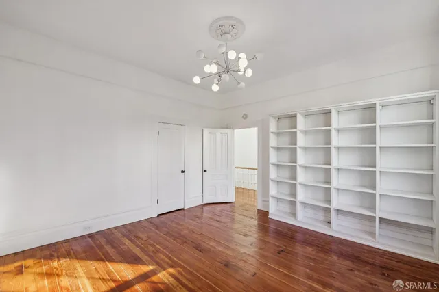a view of wooden floor and windows in a room