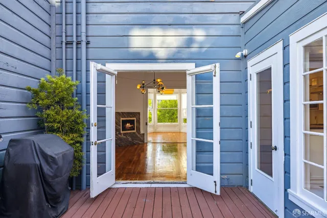 a view of front door and porch with wooden floor