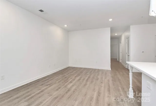 a view of a room with wooden floor