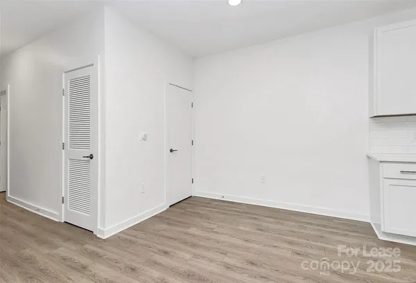 a view of a room with wooden floor