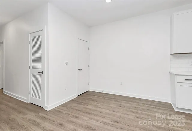 a view of a room with wooden floor