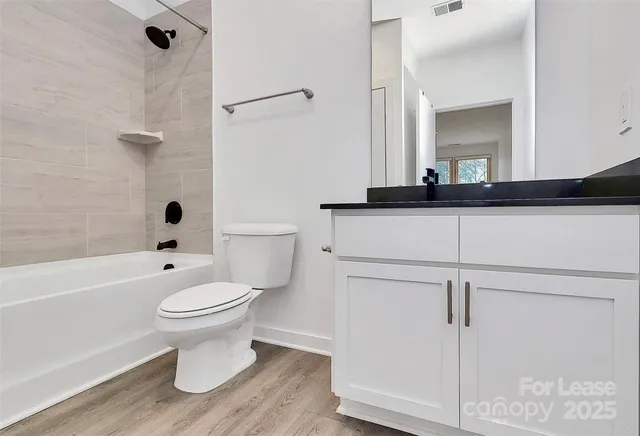 a bathroom with a sink toilet a mirror and shower